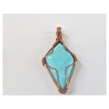 Turquoise pendant wrapped in copper wire