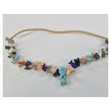 Necklace with many carved stone animals, the cente