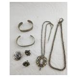 Several pieces of silver-tone costume jewelry