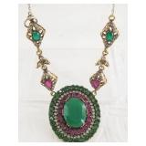 Silver tone artisan necklace with low grade emeral