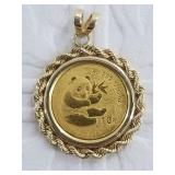 Gold panda coin in bezel, bezel is marked 14k tota