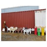 Outdoor wood depiction of sled dogs and mushers