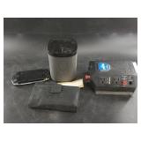 Lot with a Sonos brand speaker, surge protector, a