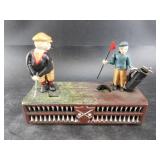 Cast iron coin bank depicting golfers, contemporar