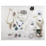 Variety of mostly silver-toned fashion jewelry, in