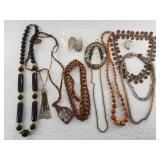 Variety of mostly earth-toned themed fashion jewel