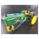 Vintage John Deere moving tractor with both arms,