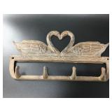 Adorable cast iron swan pair forming a heart wall