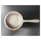 Cast iron ladle with legs about 7in long.