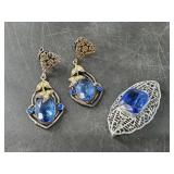 Brooch and earring set with faceted blue center st