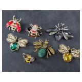 Several enameled gold-tone bumble bee brooches