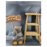 Bear holding a 'Welcome' sign and a small step lad