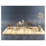 Brass desert figurines on an onyx base