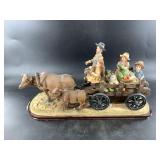 Resin figurine of an ox and cart and family on way