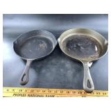 Two contemporary cast iron skillets