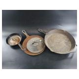 Several pieces of cast iron, mostly Lodge