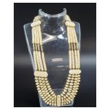 Necklace with carved bone and brass beads