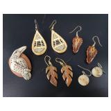 Several Alaskan themed earrings with a white raven