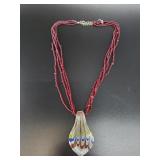 Artisan glass pendant and a multi-strand necklace