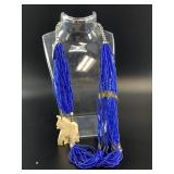 Multi-strand necklace with a bone carved elephant