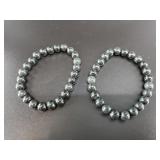 Pair of dark green stretch bracelets
