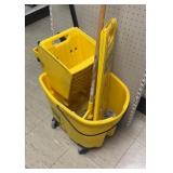 Mop and bucket and wet floor sign