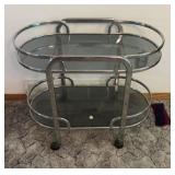 Chrome rolling table with glass shelves