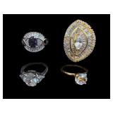 4 PC LOT OF COSTUME CLEAR/PURPLE STONE RINGS
