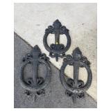 3 CAST IRON RING AND TORCH WALL HANGERS