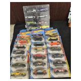 21 Hot Wheels  in packaging and 8 pickups in a