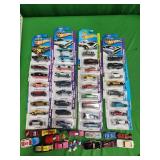 34 Hot Wheels cars in packages and assorted other