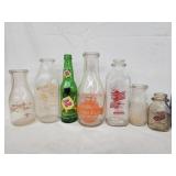 6 milk bottles and 1 Sun Drop bottle.   Various