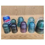9 glass insulators.  Various ages and conditions.