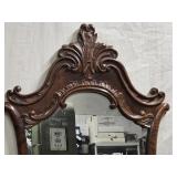 Art Nouveau era mirror hand carving around frame.
