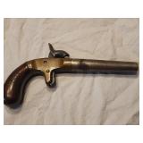 Cap and Ball single shot derringer style pistol.