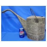 Galvanized watering can.   Old repair on back.