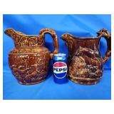 2 Hounds Handled Rockingham stoneware pitchers.