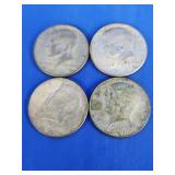 4 Kennedy Half dollar coins.  Three 1966 and