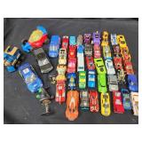 24 Hot Wheels and other makers Cars and trucks.