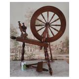 Spinning wheel with foot pedal.