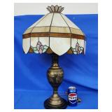Slag and stained glass shade on brass lamp with