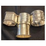4 sterling silver napkin rings.  NOT matching.