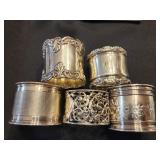 5 Sterling silver Napkin rings.   Not matching.