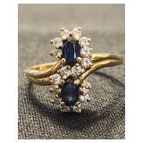 14 K gold ring with 2 sapphire and clear stones.