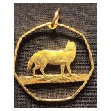 Hand cut coin pendant of wolf from British 50