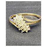 10 K ring.  Bypass style band with cluster of