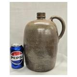 Stoneware Jug with hand grip handle , small chip