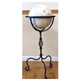Vintage white globe in black metal floor stand