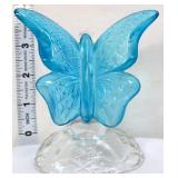 Fenton aqua blue butterfly on clear branch