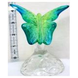 Fenton blue/green butterfly on clear branch